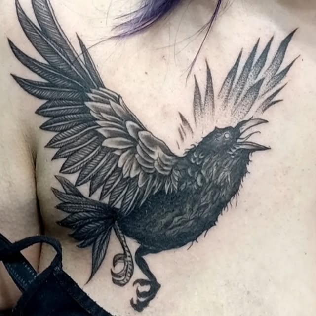 Close-up detailed professional photography of a master tattoo artist working on an intricate black and grey realism sleeve tattoo with needle machine in a dark moody high-end tattoo studio with warm ambient red rim lighting and soft shadows